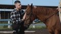 Horse Club. A married couple in training with horses. A man pets a horse. Woman rider on horseback. Young couple on a Royalty Free Stock Photo