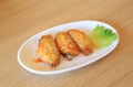 New Orleans Chicken Wings in white plate on wood table background. Royalty Free Stock Photo