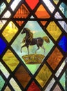 Horse and crown on stained glass