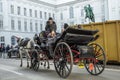 Horse-drawn carriage carrying tourists along the old streets of Vienna, Austria, 12/27/2019 Royalty Free Stock Photo