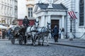 Horse-drawn carriage carrying tourists along the old streets of Vienna, Austria, 12/27/2019 Royalty Free Stock Photo