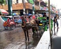 A horse-drawn carriage and pedicabs on Malioboro street, Jogjakarta, Indonesia
