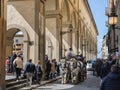 Horse-drawn Carriage with Tourists and Two White Horses Traveling along a Road near Arno River and Ponte Vecchio in Florence, Royalty Free Stock Photo