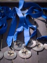 Horse Dressage medals with blue ribbon on a table.