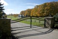 A horse farm entrance with an iron gate