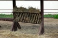 Horse feeder hay. Rural scene. Convenient feeder for cattle Royalty Free Stock Photo