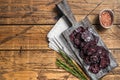 Horse game meat cured sausage with rosemary on a cutting board. Wooden background. Top view. Copy space Royalty Free Stock Photo