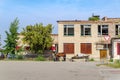 A horse harnessed to a cart near an abandoned building of the House of Culture in a Russian village Royalty Free Stock Photo