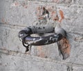 Horse hitching ring on a roughly plastered wall Royalty Free Stock Photo