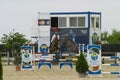 Equitation contest, horse jumping over obstacle