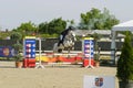 Equitation contest, horse jumping over obstacle