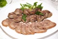 Horse meat on a plate, horse meat sausage delicacy