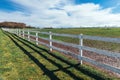 Horse paddock white wooden fence on equestrian farm Royalty Free Stock Photo