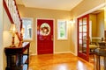 Horse ranch entryway with red door and hardwood floor.