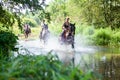 Horse ride, young girls riders, crossing a river on horseback. Royalty Free Stock Photo