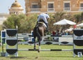 Horse and rider jumping in equestrian competition