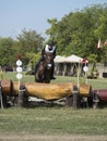 Horse rider jumping over a barrier Royalty Free Stock Photo