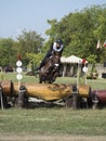 Horse rider jumping over a barrier Royalty Free Stock Photo