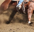 A horse and rider moving fast with dirt flying. Royalty Free Stock Photo