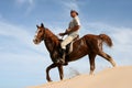 Horse rider on sand dune