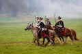 Horse riders holding swords forward at Borodino battle historical reenactment in Russia