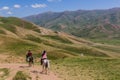 Horse riders in mountains near Song Kul lake, Kyrgyzst Royalty Free Stock Photo