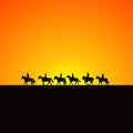 Horse riders silhouettes at sunrise