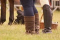 Horse riders standing with a horse