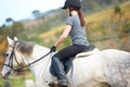 Horse riding, back or woman in countryside outdoor with rider or jockey for recreation or wellness. Sports, ready or Royalty Free Stock Photo