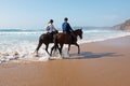 Horse riding at the beach at the ocean Royalty Free Stock Photo