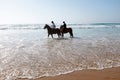 Horse riding at the beach at the ocean Royalty Free Stock Photo