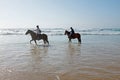 Horse riding at the beach at the ocean Royalty Free Stock Photo