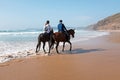 Horse riding at the beach at the ocean Royalty Free Stock Photo