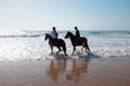 Horse riding at the beach at the ocean Royalty Free Stock Photo