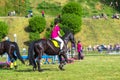 In the Horse Riding Championship, a female jockey skillfully controls a black horse, racing towards victory, Grudziadz, Poland -