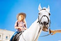 Blonde-haired teenage girl enjoying her horse riding lesson Royalty Free Stock Photo