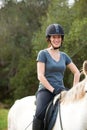 Horse riding, nature or portrait of happy woman in countryside outdoor with jockey for recreation. Sports, smile or Royalty Free Stock Photo