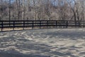 Horse riding ring with black fence, sand and rubber base