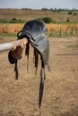 Horse saddle on rural fence Royalty Free Stock Photo