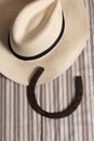 Horse shoe on table in cowboy hat with good luck symbol. West talisman. Royalty Free Stock Photo