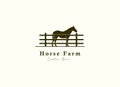 Horse silhouette behind wooden fence paddock for vintage retro rustic countryside western country farm ranch logo design Royalty Free Stock Photo