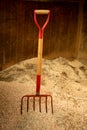 Horse stable witth straw fork tool, sawdust Royalty Free Stock Photo