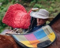 Horse trainer saddling a horse for the first time