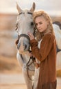 Horse and woman close beauty portrait in traditional leather clothes