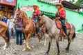 Horseback cowboys ride in village, Guatemala