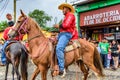 Horseback cowboys ride in village, Guatemala