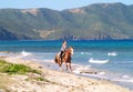 Horseback riding on beach. Royalty Free Stock Photo