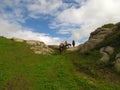 Horseback riding in the high mountain countryside Royalty Free Stock Photo