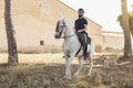 A horseman riding a horse with his dog Royalty Free Stock Photo