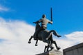 Horseman with sword, monument to victory on background of blue sky with white clouds